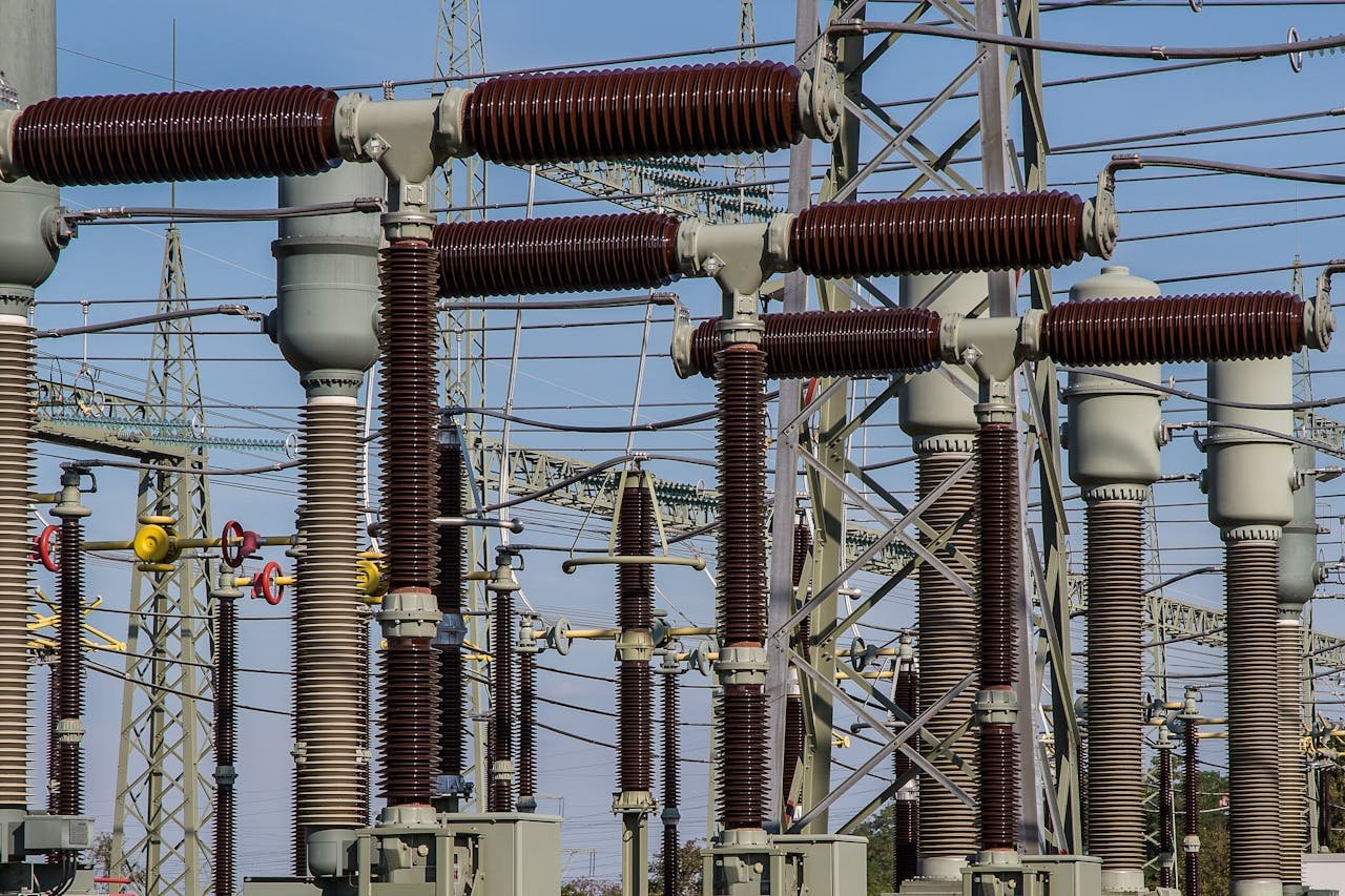 About Detailed view of high voltage electrical substation with transformers and power lines.